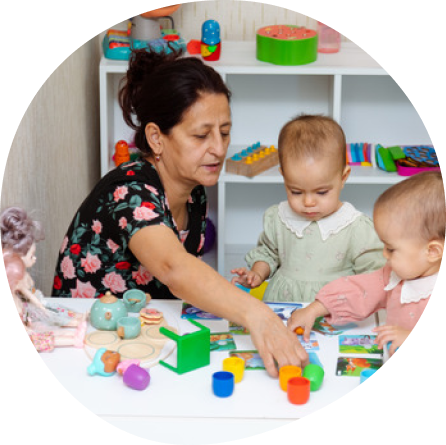 Caregiver engaging infants in gentle learning activities at Midland's Playful Scholars