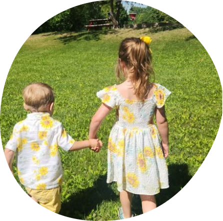 Two children holding hands at Playful Scholars, Midland, MI.