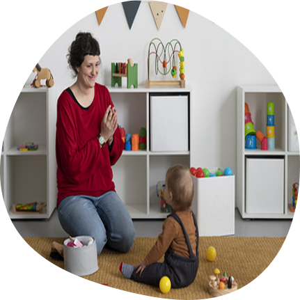 Educator and toddler engaged at Playful Scholars in Midland, offering affordable early learning through subsidies.