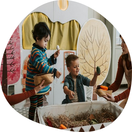 Preschool children playing creatively at Playful Scholars daycare in Midland, MI, fostering learning and joyful discovery.