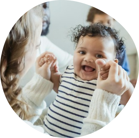 Smiling baby enjoying trusted infant care at Playful Scholars in Midland, MI, emphasizing safety and gentle learning.