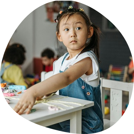 Preschool child engaged in creative play at Playful Scholars in Midland, MI daycare.