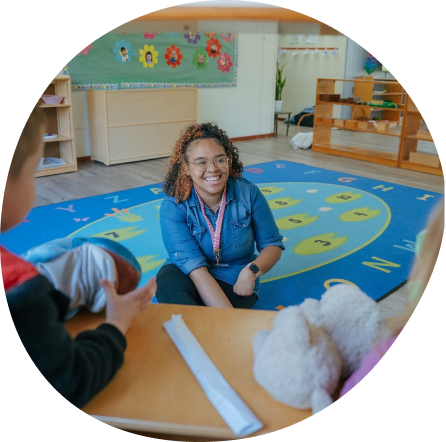 Teacher engaging with children at Playful Scholars preschool in Midland, fostering curiosity and community.