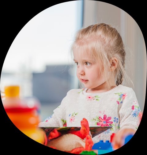 Young child learning through play at Playful Scholars preschool in Midland, MI, fostering curiosity and friendships.