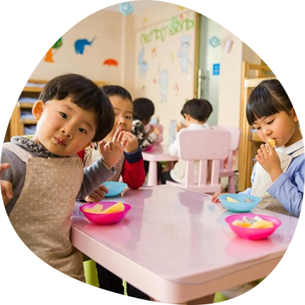 Toddlers enjoying snacks at Playful Scholars, Midland MI, fostering curiosity and joyful learning.