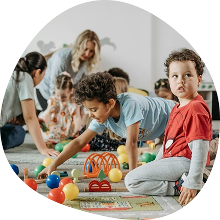 Toddlers exploring toys at Playful Scholars daycare in Midland, MI, fostering curiosity and joyful learning.